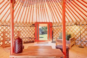 a large yurt with a wooden floor and a door at Jurte Falken Nest in Eisenbach