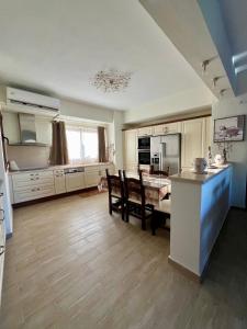 a kitchen and dining room with a table and chairs at Psichro Apartments Hera in Magoulás