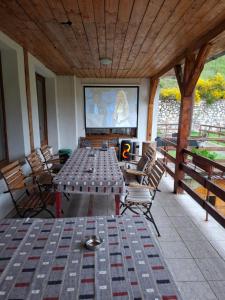 a screened porch with a table and chairs and a screen at Vila Apuseni in Arieşeni