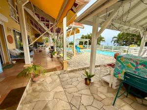 a resort with a swimming pool and a patio at VILLA PASKEDRA in Case-Pilote