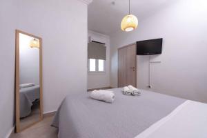 a bedroom with a bed with two towels on it at Angie's House Volos in Volos