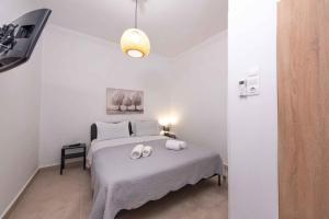a bedroom with a bed with two towels on it at Angie's House Volos in Volos