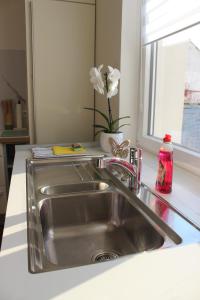 a stainless steel sink in a kitchen with a window at Lem-Lux in Lemgo +33 photos
