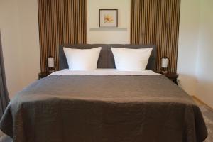 a bedroom with a large bed with two pillows at Lem-Lux in Lemgo
