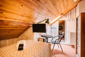 a bedroom with a bed and a table with a tv at Graça Guest House in Lisbon