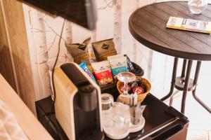 a table with a coffee maker and a table with a side table at Graça Guest House in Lisbon