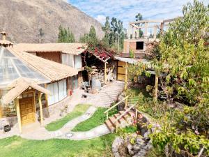 a house with a garden in front of a mountain at Arins House in Cusco