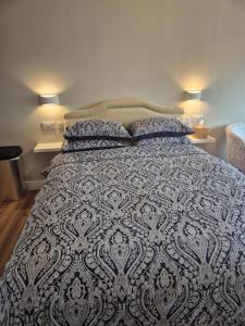 a bedroom with a large bed with two lamps at taigh beag in Fort William