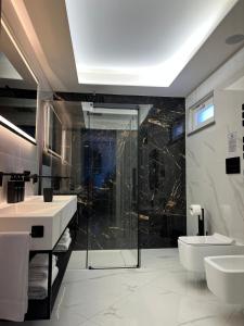 a bathroom with two sinks and a shower and a toilet at Green House in Vico Equense
