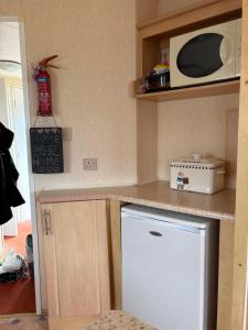 a kitchen with a white refrigerator and a microwave at Jay Valley Van in Flamborough