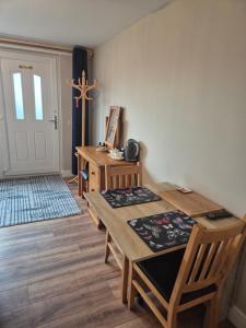 a room with a table and chairs and a door at taigh beag in Fort William