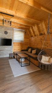 a living room with a couch and a swing at Guest House Zabljak in Žabljak