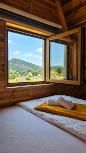 a bedroom with a bed and a large window at Guest House Zabljak in Žabljak +8 photos