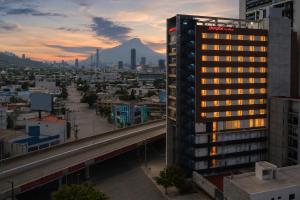 a view of a city with a mountain in the background at Hampton by Hilton Monterrey Tecnológico in Monterrey