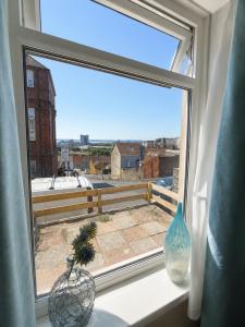 a window with two vases sitting on a window sill at 52 - room 1 - city views in Swansea