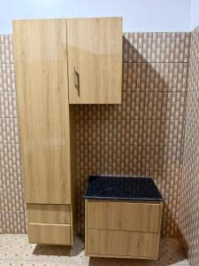 a bathroom with two wooden cabinets and a counter at Umunota Escape in Bugesera