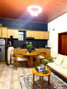 a woman standing in the kitchen of a living room at Umunota Escape in Bugesera