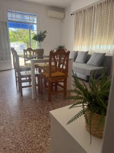 a living room with a couch and a table and chairs at La Barraca in Gandía