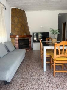 a living room with a couch and a fireplace at La Barraca in Gandía