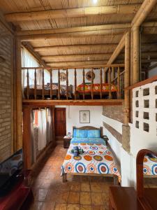 a bedroom with a bed in a house at Hospedaje La Tierrita Villa de Leyva in Villa de Leyva