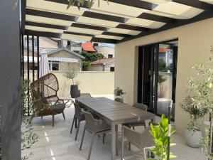 a patio with a wooden table and chairs at Luxury Villa Olga in Biograd na Moru