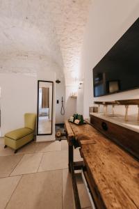 a living room with a table and a yellow chair at Nobile Dimora di Puglia in Ostuni +11 photos