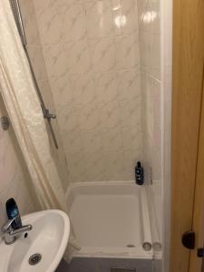 a small bathroom with a sink and a shower at Rooms MADI in Split