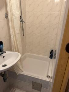 a bathroom with a tub and a sink and a shower at Rooms MADI in Split