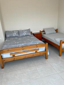 a bedroom with two beds in a room at Pogradec Lakefront Apartment in Pogradec