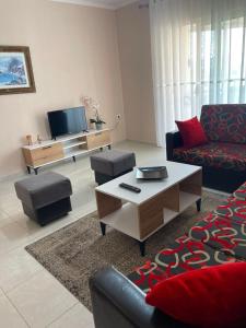 a living room with a couch and a coffee table at Pogradec Lakefront Apartment in Pogradec