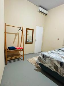a bedroom with a bed and a mirror in it at Pousada Amiga in Parintins +27 photos