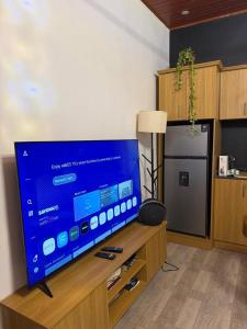 a living room with a large flat screen tv at Umunota Escape in Bugesera