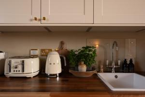a kitchen counter top with a toaster and a toaster at The Townhouse, Leith in Edinburgh