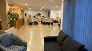 a living room with a couch and tables and chairs at Hosteria Arenas in Mina Clavero +41 photos