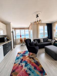 a living room with a couch and a rug at Ada Hill Ayvalık in Ayvalık