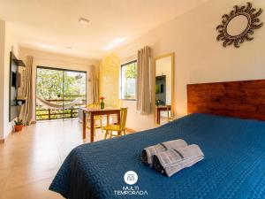 a bedroom with a blue bed with a toy car on it at Lugar ao Sol - Flats c/ Cozinha no Rosa in Praia do Rosa
