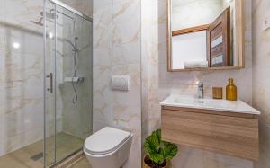 a bathroom with a shower and a toilet and a sink at Lotus Resort B&B in Pula +17 photos