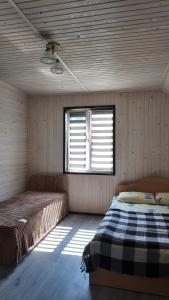 a bedroom with two beds in a room with a window at Оксана та Назар in Mykulychyn