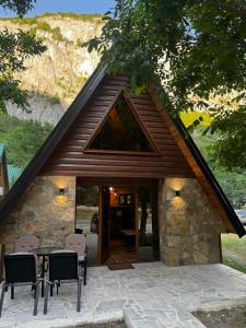 a small stone house with a table and chairs at Villa Komarnica Hideaway in Šavnik