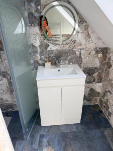 a bathroom with a white sink and a mirror at Zimmer in Wattenbek in Wattenbek