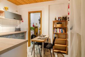 a kitchen with a table and chairs in a room at Schwarzwald Nescht Triberg in Triberg +15 photos
