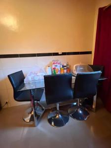 a table and two chairs in a room at Spacious Apartment with Pool in M'bour - 100 m² in Mbour +6 photos