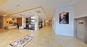 a lobby with a picture of a man on a wall at Ceti̇n Presti̇ge Resort in Erdek +56 photos