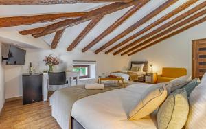 a bedroom with two beds and a living room at Lotus Resort B&B in Pula