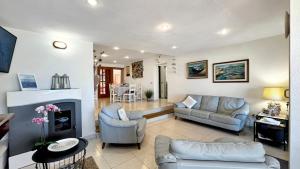 a living room with a couch and a fireplace at Villa Mica in La Maddalena