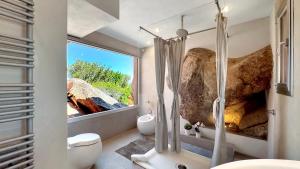a bathroom with a shower and a large window at Villa Mica in La Maddalena +72 photos