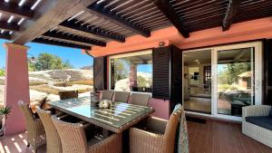 an outdoor dining area with a table and chairs at Villa Mica in La Maddalena