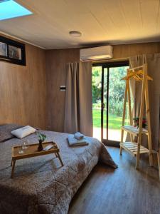 a bedroom with a bed with a table and a ladder at Bio Espacio in Belén de Escobar
