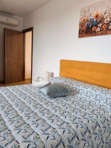 a bedroom with a large bed with a blue comforter at La Vigna 1803 in Casa Gagliano