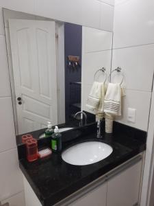 a bathroom with a sink and a mirror at Machado Monteiro in Guarapari +24 photos